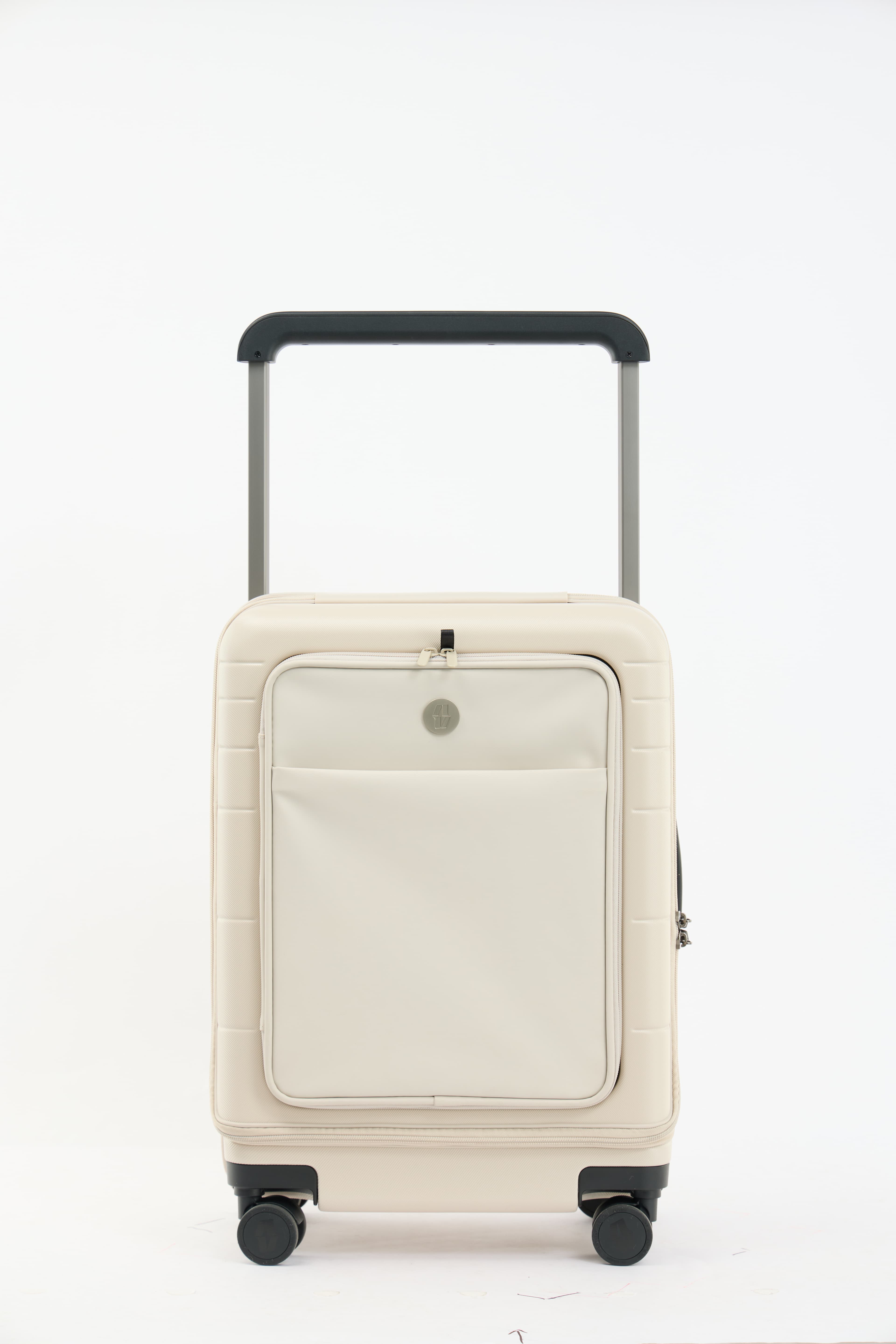 Oat-cream Vasy carry-on standing front-on with its telescopic handle extended.